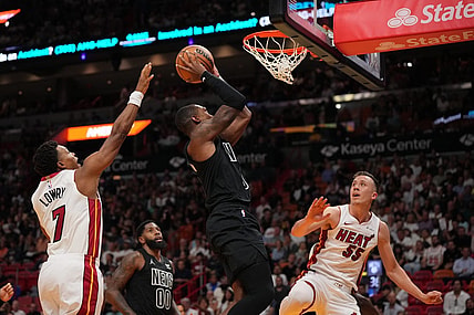 Nov 1, 2023; Miami, Florida, USA; Brooklyn Nets guard Lonnie Walker IV (8) puts up a shot between Miami Heat guard Kyle Lowry (7) and forward Duncan Robinson (55) during the first half at Kaseya Center. Mandatory Credit: Jasen Vinlove-USA TODAY Sports