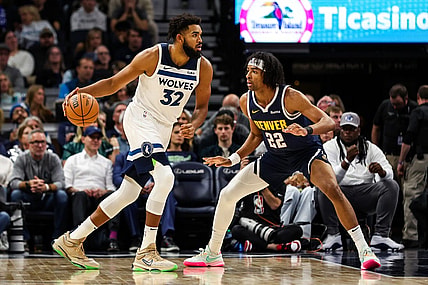 Nov 1, 2023; Minneapolis, Minnesota, USA; Minnesota Timberwolves center Karl-Anthony Towns (32) dribbles while Denver Nuggets forward Zeke Nnaji (22) defends during the first half at Target Center. Mandatory Credit: Matt Krohn-USA TODAY Sports