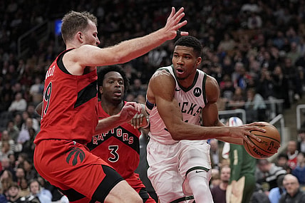 Nov 1, 2023; Toronto, Ontario, CAN; Milwaukee Bucks forward Giannis Antetokounmpo (34) tries to pass the ball against Toronto Raptors center Jakob Poeltl (19) during the second half at Scotiabank Arena. Mandatory Credit: John E. Sokolowski-USA TODAY Sports