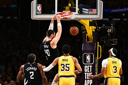 Nov 1, 2023; Los Angeles, California, USA;  LA Clippers center Ivica Zubac (40) dunks the ball against Los Angeles Lakers forward Christian Wood (35) and guard D'Angelo Russell (1) during the first quarter at Crypto.com Arena. Mandatory Credit: Jonathan Hui-USA TODAY Sports