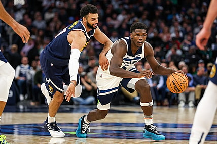 Nov 1, 2023; Minneapolis, Minnesota, USA; Minnesota Timberwolves guard Anthony Edwards (5) drives while Denver Nuggets guard Jamal Murray (27) defends during the second half at Target Center. Mandatory Credit: Matt Krohn-USA TODAY Sports