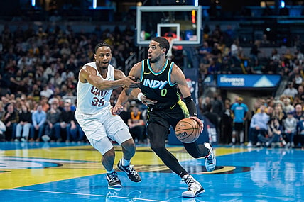 Nov 3, 2023; Indianapolis, Indiana, USA; Indiana Pacers guard Tyrese Haliburton (0) dribbles while Cleveland Cavaliers forward Isaac Okoro (35) defends in the first half at Gainbridge Fieldhouse. Mandatory Credit: Trevor Ruszkowski-USA TODAY Sports