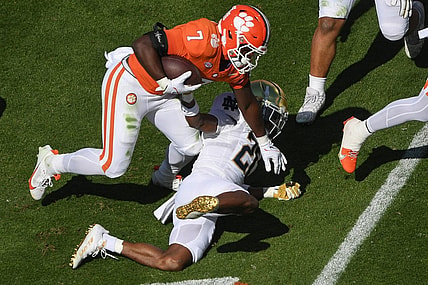 Nov 4, 2023; Clemson, South Carolina, USA; Clemson Tigers running back Phil Mafah (7) runs against Notre Dame Fighting Irish safety Adon Shuler (21) during the first quarter at Memorial Stadium. Mandatory Credit: Ken Ruinard-USA TODAY Sports