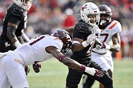 Nov 4, 2023; Louisville, Kentucky, USA;  Louisville Cardinals running back Jawhar Jordan (25) runs the ball against Virginia Tech Hokies linebacker Keli Lawson (21) during the first quarter at L&N Federal Credit Union Stadium. Mandatory Credit: Jamie Rhodes-USA TODAY Sports