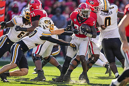 Nov 4, 2023; Athens, Georgia, USA; Georgia Bulldogs running back Daijun Edwards (30) runs against Missouri Tigers linebacker Chuck Hicks (30) during the first half at Sanford Stadium. Mandatory Credit: Dale Zanine-USA TODAY Sports