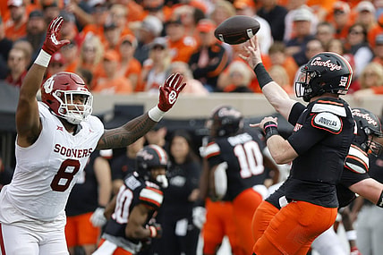 Nov 4, 2023; Stillwater, Oklahoma, USA; Oklahoma State Cowboys quarterback Alan Bowman (7) throws a pass over Oklahoma Sooners defensive lineman Jonah Laulu (8) during a game at Boone Pickens Stadium. Mandatory Credit: Bryan Terry-USA TODAY Sports