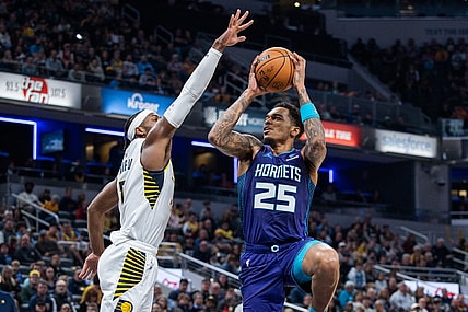 Nov 4, 2023; Indianapolis, Indiana, USA; Charlotte Hornets forward P.J. Washington (25) shoots the ball whileIndiana Pacers guard Buddy Hield (7)  defends in the first half at Gainbridge Fieldhouse. Mandatory Credit: Trevor Ruszkowski-USA TODAY Sports