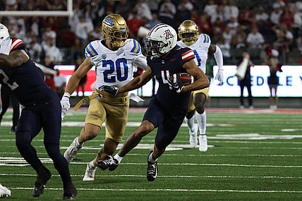 Nov 4, 2023; Tucson, Arizona, USA; Arizona Wildcats wide receiver Tetairoa McMillan #4 makes a catch for a first down against UCLA Bruins linebacker Kain Medrano #20 during the first half at Arizona Stadium. Mandatory Credit: Zachary BonDurant-USA TODAY Sports