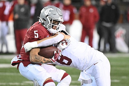 Nov 4, 2023; Pullman, Washington, USA; Washington State Cougars wide receiver Lincoln Victor (5) is stopped alert short gain by Stanford Cardinal linebacker Tristan Sinclair (8) in the second half at Gesa Field at Martin Stadium. Stanford won 10-7. Mandatory Credit: James Snook-USA TODAY Sports