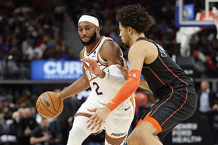 Nov 5, 2023; Detroit, Michigan, USA;  Phoenix Suns forward Josh Okogie (2) dribbles defended by Detroit Pistons guard Cade Cunningham (2) in the first half at Little Caesars Arena. Mandatory Credit: Rick Osentoski-USA TODAY Sports