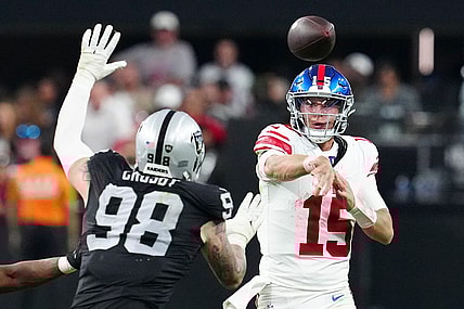 Nov 5, 2023; Paradise, Nevada, USA; New York Giants quarterback Tommy DeVito (15) is pressured by Las Vegas Raiders defensive end Maxx Crosby (98) during the fourth quarter at Allegiant Stadium. Mandatory Credit: Stephen R. Sylvanie-USA TODAY Sports