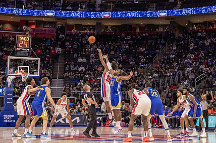Nov 6, 2023; Detroit, Michigan, USA; Detroit Pistons forward Marvin Bagley III (35) and Golden State Warriors forward Kevon Looney (5) jump for the basketball to start the game at Little Caesars Arena. Mandatory Credit: David Reginek-USA TODAY Sports