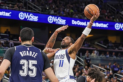 Nov 6, 2023; Orlando, Florida, USA; Dallas Mavericks guard Kyrie Irving (11) drives to the basket against Orlando Magic center Goga Bitadze (35) during the first quarter at Amway Center. Mandatory Credit: Mike Watters-USA TODAY Sports