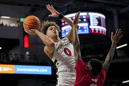 Nov 6, 2023; Cincinnati, Ohio, USA;  Cincinnati Bearcats guard Dan Skillings Jr. (0) drives to the basket against Illinois-Chicago Flames guard Steven Clay (2) in the first half at Fifth Third Arena. Mandatory Credit: Aaron Doster-USA TODAY Sports