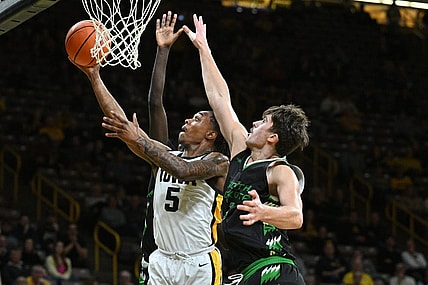 Nov 7, 2023; Iowa City, Iowa, USA; Iowa Hawkeyes guard Dasonte Bowen (5) drives against North Dakota Fighting Hawks forward Amar Kuljuhovic (3) during the first half at Carver-Hawkeye Arena. Mandatory Credit: Jeffrey Becker-USA TODAY Sports