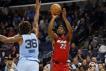 Nov 8, 2023; Memphis, Tennessee, USA; Miami Heat forward Jimmy Butler (22) shoots for three as Memphis Grizzlies guard Marcus Smart (36) defends during the first half at FedExForum. Mandatory Credit: Petre Thomas-USA TODAY Sports