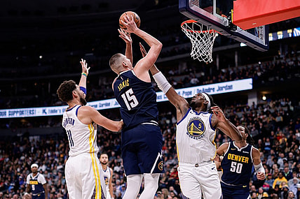 Nov 8, 2023; Denver, Colorado, USA; Denver Nuggets center Nikola Jokic (15) attempts a shot against Golden State Warriors forward Kevon Looney (5) and guard Klay Thompson (11) in the third quarter at Ball Arena. Mandatory Credit: Isaiah J. Downing-USA TODAY Sports