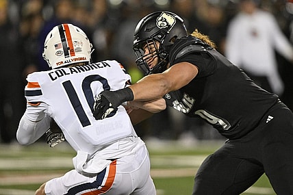 Nov 9, 2023; Louisville, Kentucky, USA; Louisville Cardinals defensive lineman Ashton Gillotte (9) sacks Virginia Cavaliers quarterback Anthony Colandrea (10) during the first quarter at L&N Federal Credit Union Stadium. Mandatory Credit: Jamie Rhodes-USA TODAY Sports