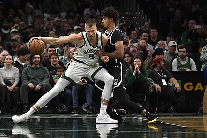 Nov 10, 2023; Boston, Massachusetts, USA;  Boston Celtics center Kristaps Porzingis (8) controls the ball while Brooklyn Nets forward Cameron Johnson (2) defends during the first half at TD Garden. Mandatory Credit: Bob DeChiara-USA TODAY Sports