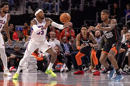 Nov 10, 2023; Detroit, Michigan, USA; Detroit Pistons guard Marcus Sasser (25) passes the ball past Philadelphia 76ers forward Robert Covington (33) during the in the first half at Little Caesars Arena. Mandatory Credit: David Reginek-USA TODAY Sports