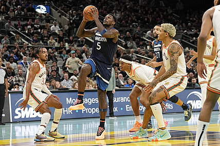 Nov 10, 2023; San Antonio, Texas, USA; Minnesota Timberwolves guard Anthony Edwards (5) drives to the basket between San Antonio Spurs forward Jeremy Sochan (10) and guard Tre Jones (33) during the second half at Frost Bank Center. Mandatory Credit: Scott Wachter-USA TODAY Sports