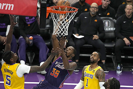 Nov 10, 2023; Phoenix, Arizona, USA; Phoenix Suns forward Kevin Durant (35) scores between Los Angeles Lakers forward Cam Reddish (5) and guard D'Angelo Russell (1) in the first half at Footprint Center. Mandatory Credit: Rick Scuteri-USA TODAY Sports