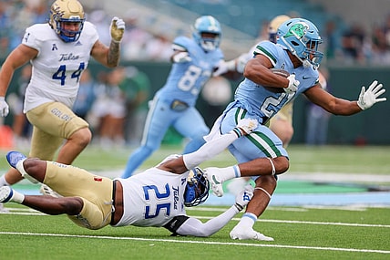 Nov 11, 2023; New Orleans, Louisiana, USA; Tulsa Golden Hurricane safety Jaise Oliver (25) tries to tackler Tulane Green Wave running back Makhi Hughes (21) in first quarter action at Yulman Stadium. Mandatory Credit: Matthew Dobbins-USA TODAY Sports