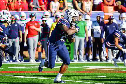 Nov 11, 2023; Lynchburg, Virginia, USA;  Liberty Flames running back Quinton Cooley (20) runs the ball in the third quarter at Williams Stadium. Mandatory Credit: Brian Bishop-USA TODAY Sports