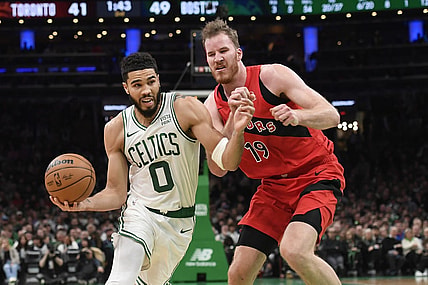 Nov 11, 2023; Boston, Massachusetts, USA;  Boston Celtics forward Jayson Tatum (0) drives to the basket past Toronto Raptors center Jakob Poeltl (19) during the first half at TD Garden. Mandatory Credit: Bob DeChiara-USA TODAY Sports