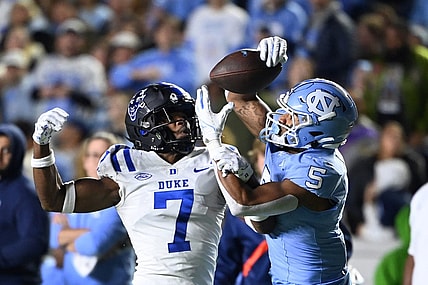 Nov 11, 2023; Chapel Hill, North Carolina, USA; North Carolina Tar Heels wide receiver J.J. Jones (5) catches the ball as Duke Blue Devils cornerback Al Blades Jr. (7) defends in the second quarter at Kenan Memorial Stadium. Mandatory Credit: Bob Donnan-USA TODAY Sports