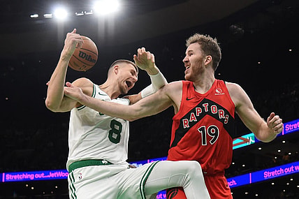 Nov 11, 2023; Boston, Massachusetts, USA;  Toronto Raptors center Jakob Poeltl (19) fouls Boston Celtics center Kristaps Porzingis (8) during the second half at TD Garden. Mandatory Credit: Bob DeChiara-USA TODAY Sports