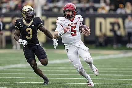 Nov 11, 2023; Winston-Salem, North Carolina, USA; Wake Forest Demon Deacons defensive back Malik Mustapha (3) chases North Carolina State Wolfpack quarterback Brennan Armstrong (5) during the first half at Allegacy Federal Credit Union Stadium. Mandatory Credit: Jim Dedmon-USA TODAY Sports