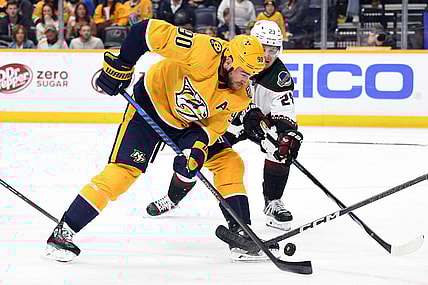 Nov 11, 2023; Nashville, Tennessee, USA; Nashville Predators center Ryan O'Reilly (90) handles the puck during the first period against the Arizona Coyotes at Bridgestone Arena. Mandatory Credit: Christopher Hanewinckel-USA TODAY Sports