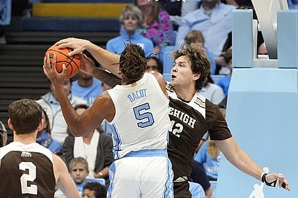 Nov 12, 2023; Chapel Hill, North Carolina, USA; Lehigh Mountain Hawks center JT Tan (42) blocks the shots of North Carolina Tar Heels forward Armando Bacot (5) in the first half at Dean E. Smith Center. Mandatory Credit: Bob Donnan-USA TODAY Sports