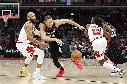 Nov 12, 2023; Chicago, Illinois, USA; Chicago Bulls guard Jevon Carter (5) defends against Detroit Pistons forward Kevin Knox II (24) during the first half at United Center. Mandatory Credit: Kamil Krzaczynski-USA TODAY Sports