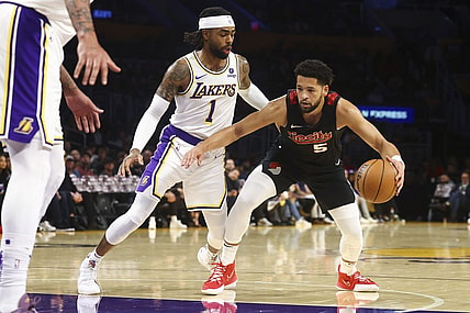 Nov 12, 2023; Los Angeles, California, USA; Portland Trail Blazers guard Skylar Mays (5) drives against the Los Angeles Lakers guard D'Angelo Russell (1) during the first half of a game at Crypto.com Arena. Mandatory Credit: Jessica Alcheh-USA TODAY Sports