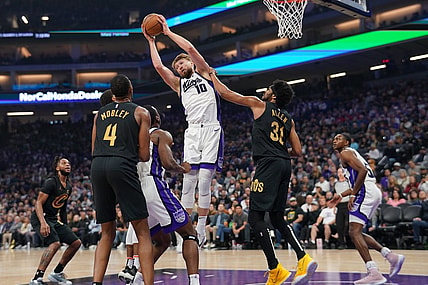 Nov 13, 2023; Sacramento, California, USA; Sacramento Kings forward Domantas Sabonis (10) grabs a rebound next to Cleveland Cavaliers center Jarrett Allen (31) in the first quarter at the Golden 1 Center. Mandatory Credit: Cary Edmondson-USA TODAY Sports