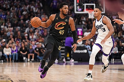 Nov 13, 2023; Sacramento, California, USA; Cleveland Cavaliers guard Donovan Mitchell (45) dribbles the ball next to Sacramento Kings forward Keegan Murray (13) in the second quarter at the Golden 1 Center. Mandatory Credit: Cary Edmondson-USA TODAY Sports