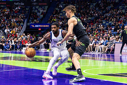 Nov 14, 2023; New Orleans, Louisiana, USA;  Dallas Mavericks guard Kyrie Irving (11) dribbles around New Orleans Pelicans guard Dyson Daniels (11) during the first half at the Smoothie King Center. Mandatory Credit: Stephen Lew-USA TODAY Sports