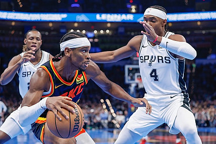 Nov 14, 2023; Oklahoma City, Oklahoma, USA; Oklahoma City Thunder guard Shai Gilgeous-Alexander (2) drives against San Antonio Spurs guard Devonte' Graham (4) during the second half at Paycom Center. Mandatory Credit: Alonzo Adams-USA TODAY Sports