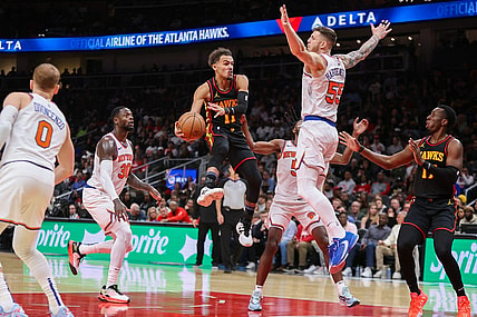 Nov 15, 2023; Atlanta, Georgia, USA; Atlanta Hawks guard Trae Young (11) passes around New York Knicks center Isaiah Hartenstein (55) in the second half at State Farm Arena. Mandatory Credit: Brett Davis-USA TODAY Sports