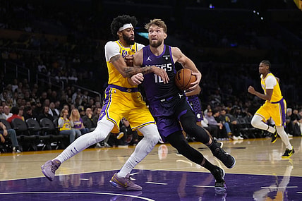 Nov 15, 2023; Los Angeles, California, USA; Sacramento Kings forward Domantas Sabonis (10) is defended by Los Angeles Lakers forward Anthony Davis (3) in the first half at Crypto.com Arena. Mandatory Credit: Kirby Lee-USA TODAY Sports