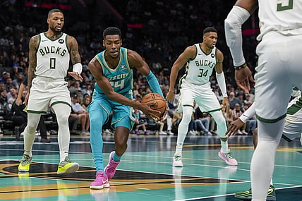 Nov 17, 2023; Charlotte, North Carolina, USA; Charlotte Hornets forward Brandon Miller (24) recovers the ball defended by Milwaukee Bucks guard Damian Lillard (0) during the first quarter at the Spectrum Center. Mandatory Credit: Jim Dedmon-USA TODAY Sports
