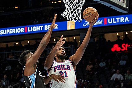 Nov 17, 2023; Atlanta, Georgia, USA; Philadelphia 76ers center Joel Embiid (21) shoots layup against Atlanta Hawks center Clint Capela (15) during the first quarter at State Farm Arena. Mandatory Credit: Jordan Godfree-USA TODAY Sports