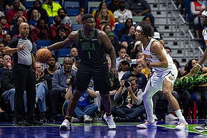Nov 17, 2023; New Orleans, Louisiana, USA;  New Orleans Pelicans forward Zion Williamson (1) dribbles against Denver Nuggets forward Zeke Nnaji (22) during the first half at the Smoothie King Center. Mandatory Credit: Stephen Lew-USA TODAY Sports