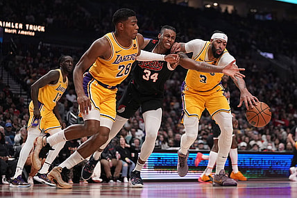 Nov 17, 2023; Portland, Oregon, USA; Portland Trail Blazers forward Jabari Walker (34) and Los Angeles Lakers power forward Rui Hachimura (28) and Anthony Davis (3) go after a loose ball during the first half at Moda Center. Mandatory Credit: Soobum Im-USA TODAY Sports