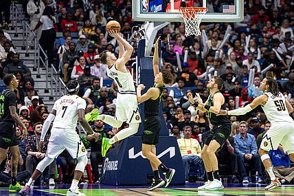 Nov 17, 2023; New Orleans, Louisiana, USA;  Denver Nuggets guard Christian Braun (0) shoots a jump shot against New Orleans Pelicans guard Dyson Daniels (11) during the second half at the Smoothie King Center. Mandatory Credit: Stephen Lew-USA TODAY Sports