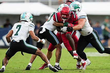 Nov 18, 2023; Boca Raton, Florida, USA; Florida Atlantic Owls wide receiver Tony Johnson (0) is tackled while running the ball against the Tulane Green Wave the first half at FAU Stadium. Mandatory Credit: Jim Rassol-USA TODAY Sports