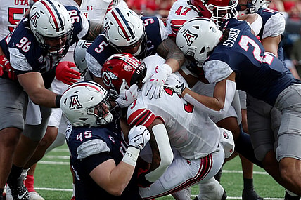 Nov 18, 2023; Tucson, Arizona, USA; Utah Utes running back Ja'Quinden Jackson (3) is tackled by Arizona Wildcats defensive lineman Bill Norton (45) and linebacker Jacob Manu (5) during the first half at Arizona Stadium. Mandatory Credit: Zachary BonDurant-USA TODAY Sports