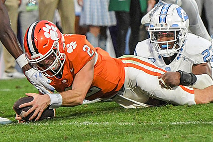 Nov 18, 2023; Clemson, South Carolina, USA; Clemson Tigers quarterback Cade Klubnik (2) dives past North Carolina Tar Heels linebacker Power Echols (23) for a touchdown during the second quarter at Memorial Stadium. Mandatory Credit: Ken Ruinard-USA TODAY Sports
